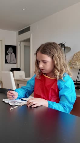 girl painting at a table
