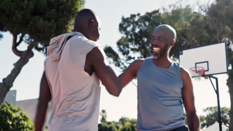 two men greeting each other on a basketball court