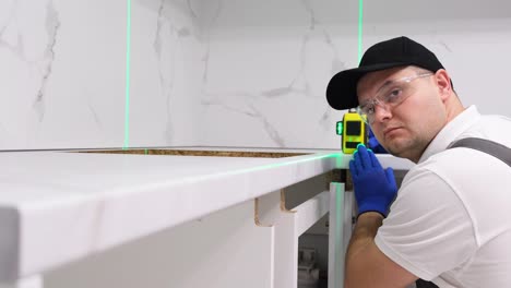 professional craftsman electrician during repair work using an electronic level professional craftsman electrician during repair work using an electronic level highquality repairs to the house