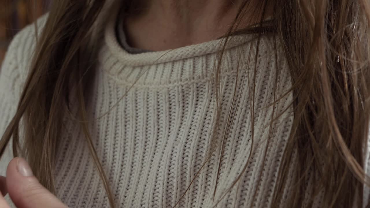 Woman playing with her long hair close up shot