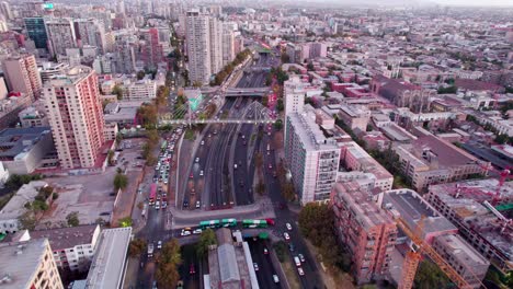 Aerial-shot-overhead-Santa-Ana-at-rush-hour-with-the-Huérfanos-bridge-crossing