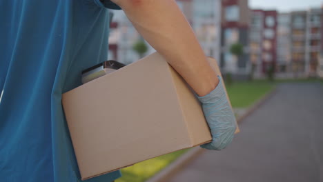 postman or delivery man carry small box deliver to customer at home contactless nfc terminal payment.