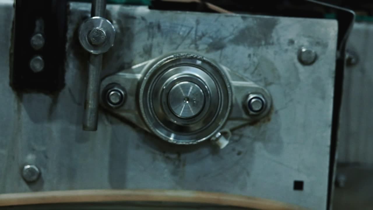 Rotating mechanical machinery driving a conveyor belt