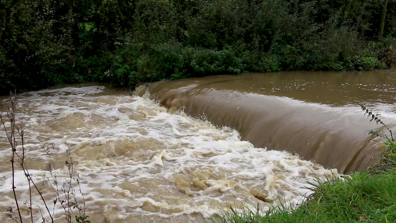 The river Gwash flowing through the village of Braunston in Rutland heavily swollen after heavy rains