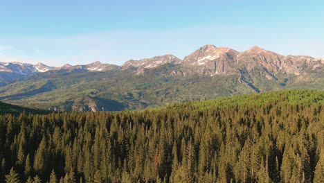 drone flying over mountain valley near kebler pass, colorado during golden hour