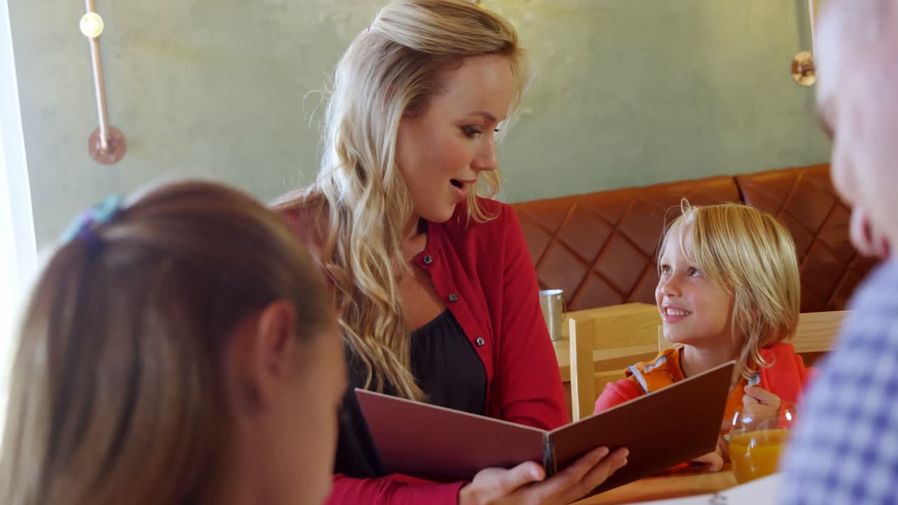 Familie kigger på menuen på restaurant 4k