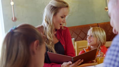 Family-looking-at-the-menu-in-restaurant-4k