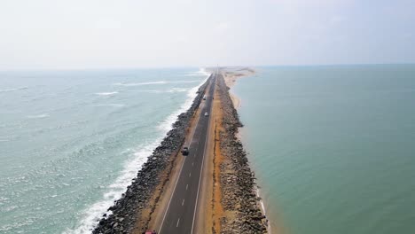 aerial drone shot of dhanushkodi’s deserted beauty, with the last road of india fading into the sea.