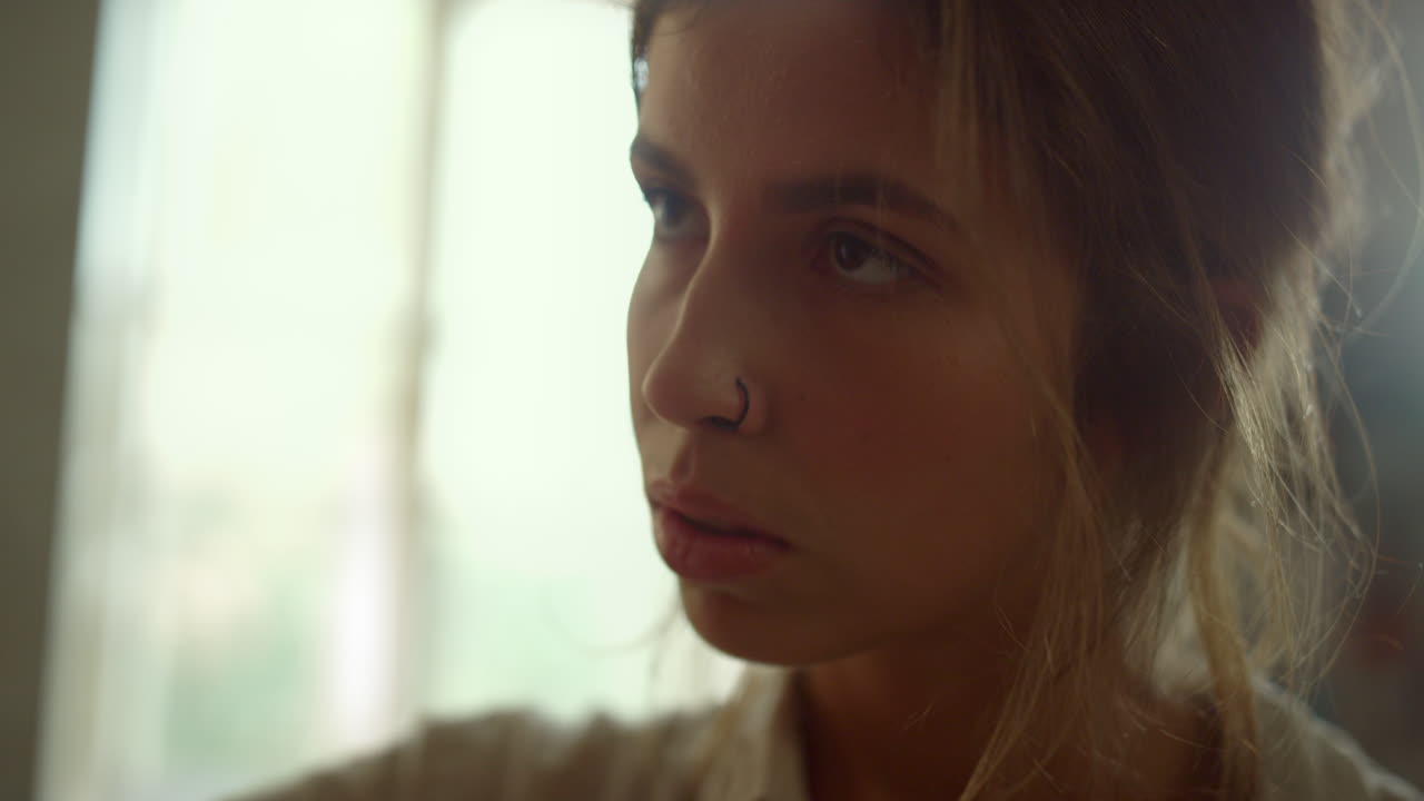 Inspired painter working in studio. Focused girl looking to artwork indoors.