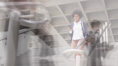 animation of african american businesswoman using smartphone over people walking