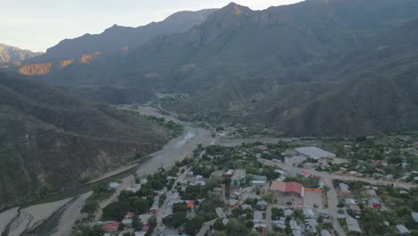 aerial drone natural environment valley small town, copper canyon urique mexico road crossing between mountain range of north latin america