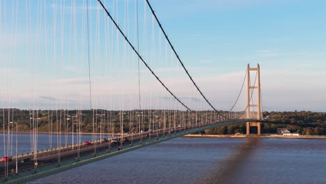 sunset serenity: aerial view of humber bridge and cars in a harmonious journey