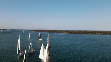 revealing view of sailing boats racing along the water in the afternoon light