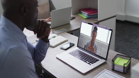 African-american-senior-man-having-a-video-call-with-female-colleague-on-laptop-at-office