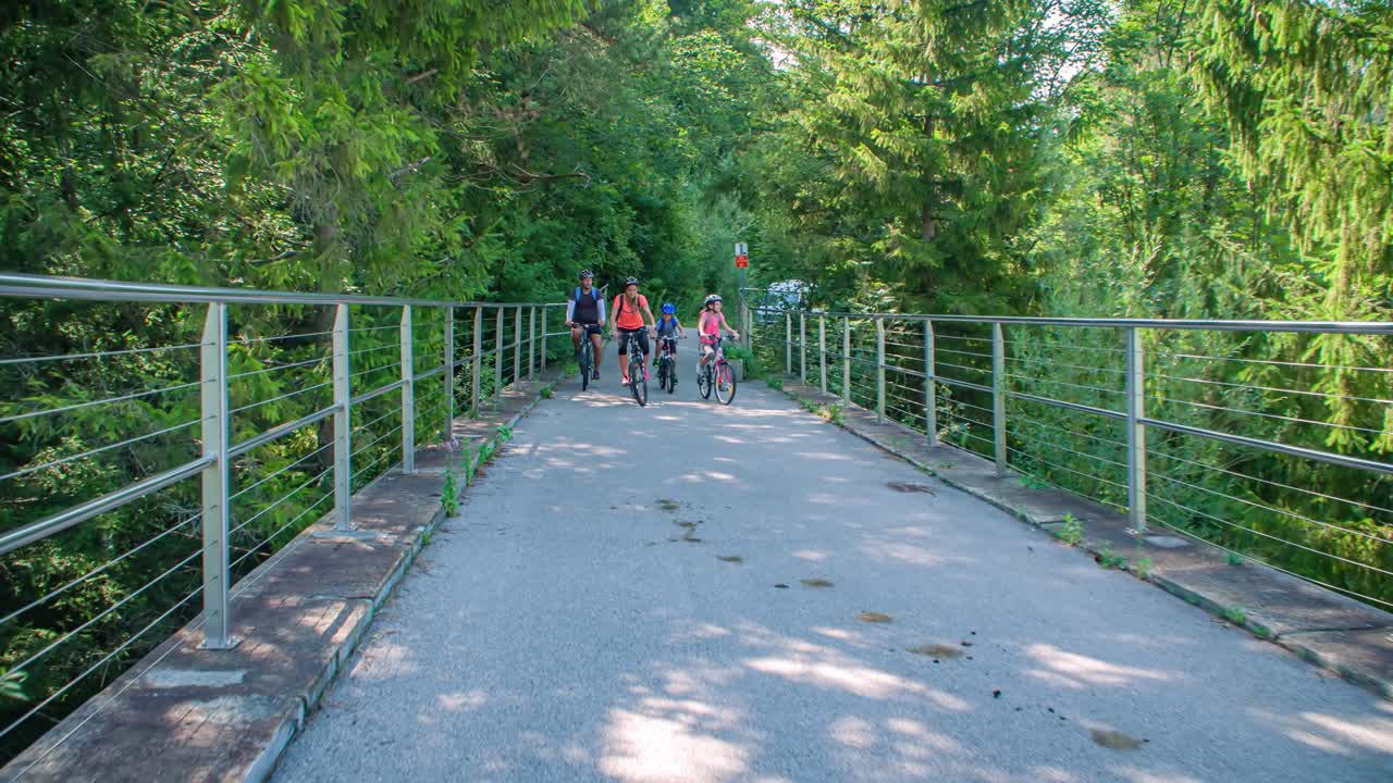 Family Cycling On Bikes On Strekna Cycle Path, Slovenia. Slow Motion