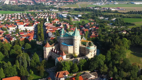 cinematic rising and revealing drone shot of castle of spirits or bojnice castle in slovakia