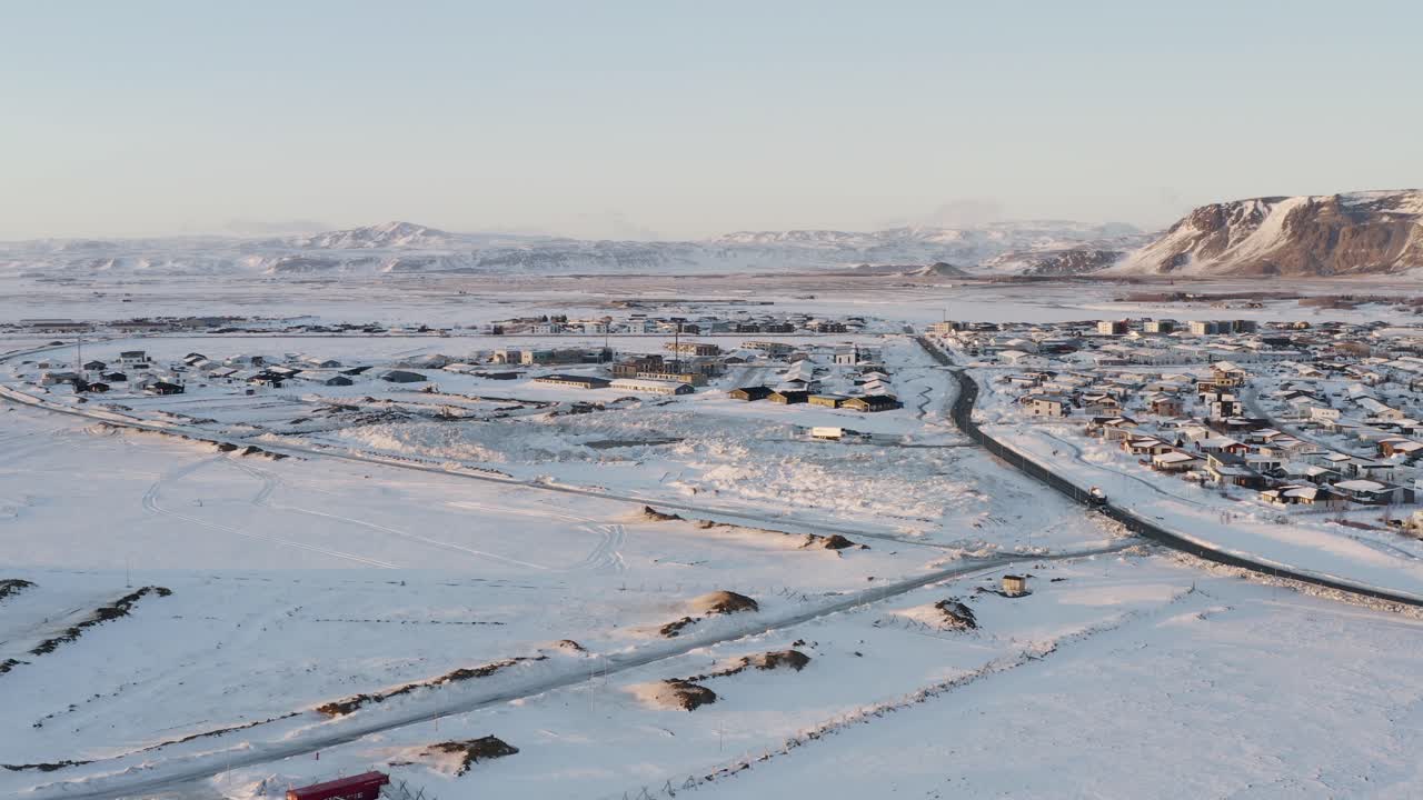 vuelo de drones de camiones que transportan nieve en la ciudad de selfoss durante el día de invierno nevado por la noche