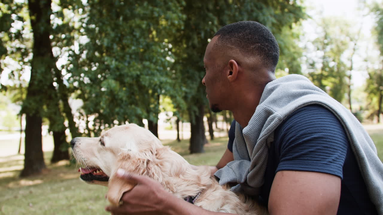 Black man with dog at the park