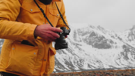 landscape photographer with dslr camera looked at his photographs