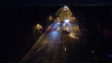 Aerial-view,-Emergency-services-response-to-road-traffic-accident-on-Brampton,-Canada,-quiet-highway-at-night