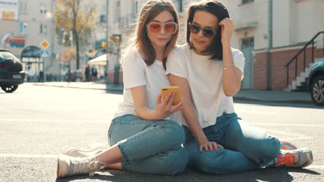 two young women taking a selfie outdoors