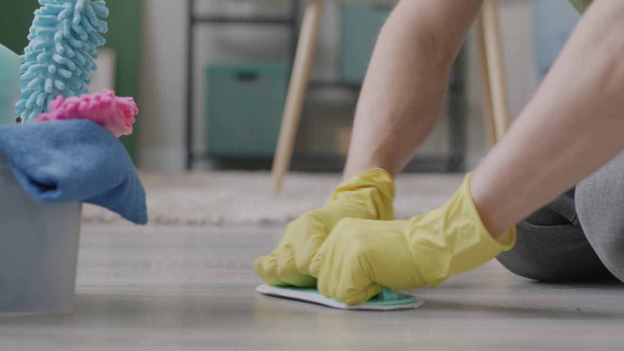 Person Cleaning the Floor with Cleaning Supplies