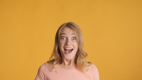 caucasian woman looking up and getting surprised on camera.