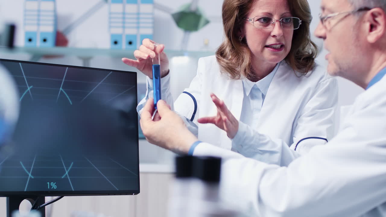 Scientists analyzing a test tube in a lab