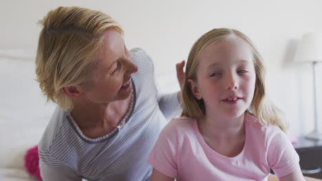 Front-view-of-Caucasian-woman-cuddling-her-daughter