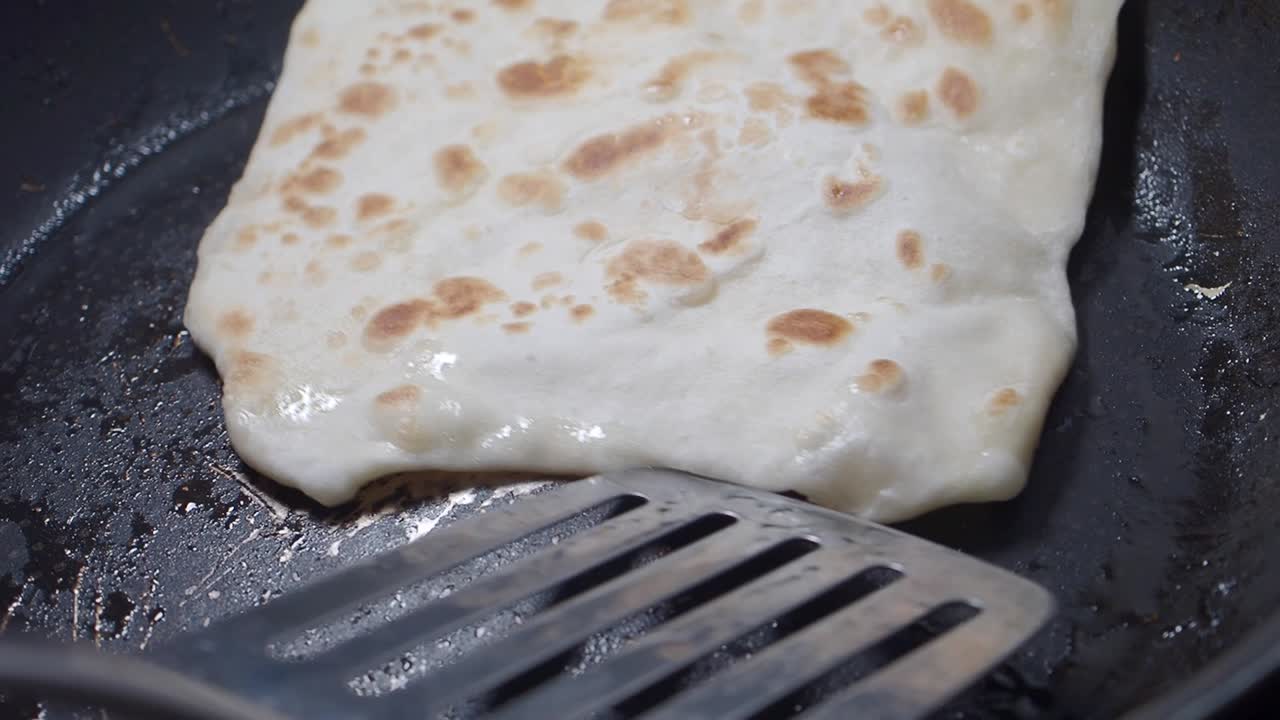 Frying Golden Brown Flatbread in a Hot Pan