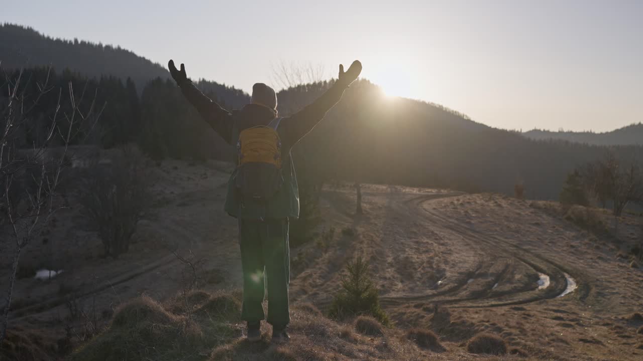 Hiker with Backpack on Mountain at Sunset