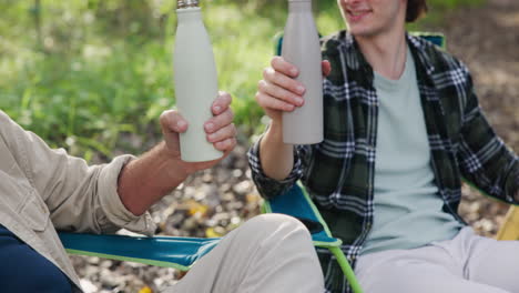 people drinking water from bottles outdoors