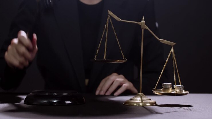 Money and gold tip the scales of justice in the courtroom - judge bangs the gavel