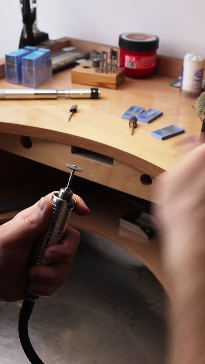 Close Up of Hands Attaching Cutting Disc to Rotary Tool on Workbench