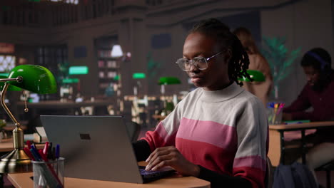 vertical video young black learner focusing on literature assignment by gathering data