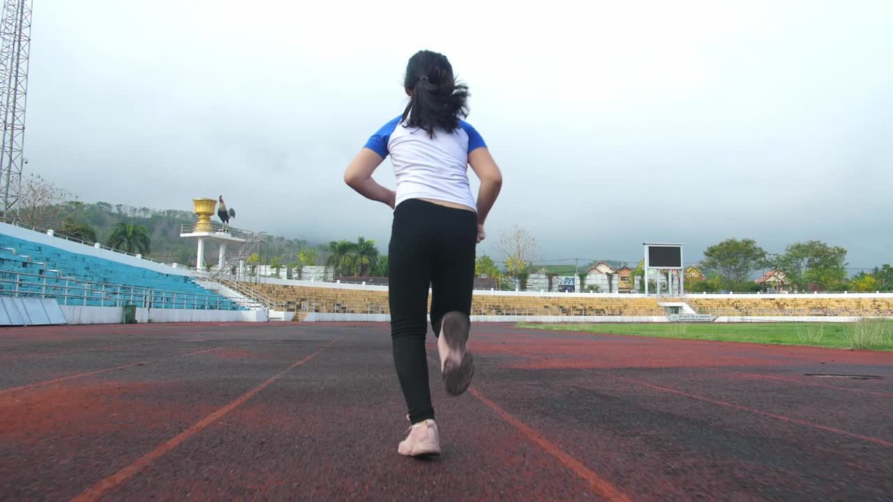 Little Girl Jogging At Stadium