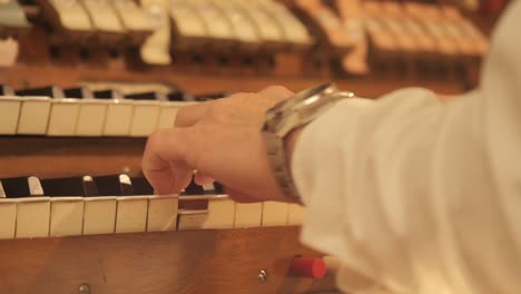 close up of musician hands playing on church piano