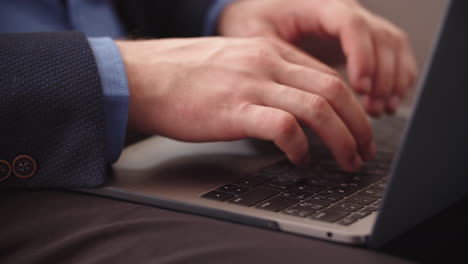 closeup man hands typing on laptop keyboard at home office in slow motion.