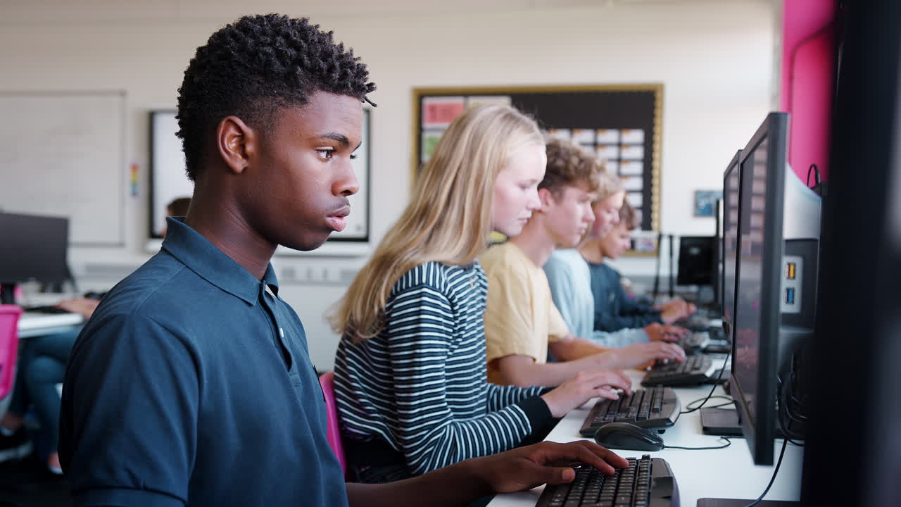 Line Of Teenage High School Students Studying In Computer Class