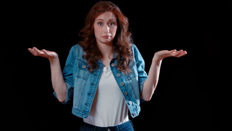 a young caucasian woman shrugs, confused