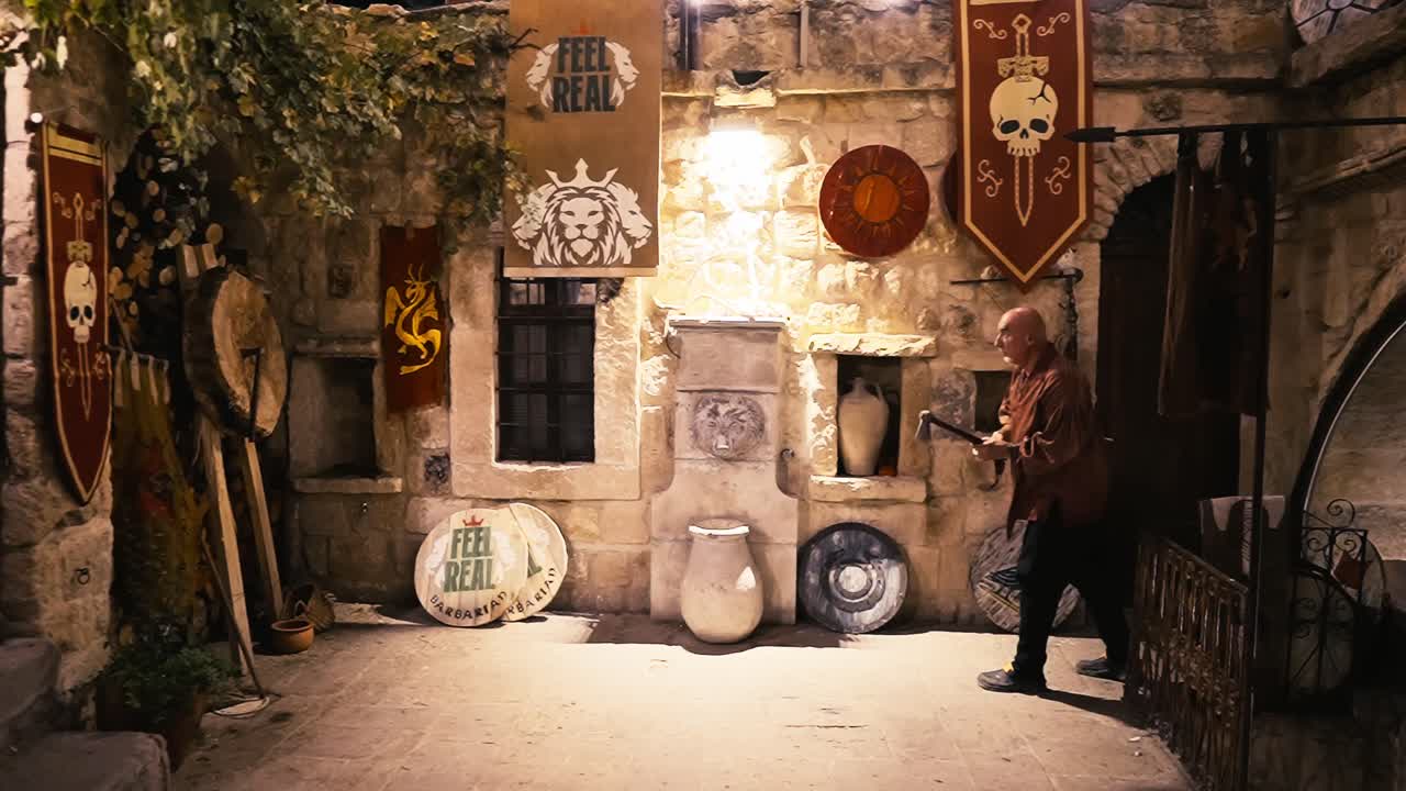 Man Throwing Axe on Wooden Target in Interior of Medieval Castle, Slow Motion, pagan barbarian culture concept