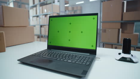 laptop in a warehouse with boxes