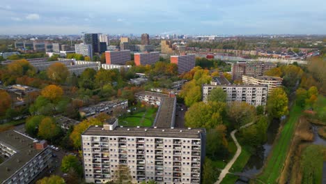 Approaching-appartment-block-from-wide-Amsterdam-cityscape-aerial