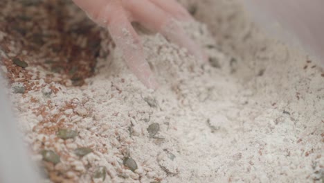 baker preparing dough from brown flour for danish rye bread