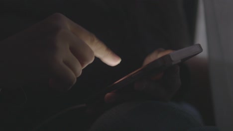 person using a smartphone in the dark