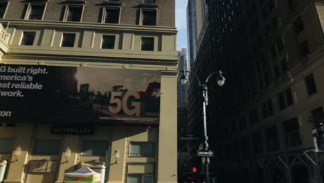 forwards fly above street between modern high rise buildings with colour facades