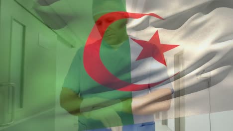 algeria flag waving against caucasian senior male health worker wearing surgical gloves at hospital