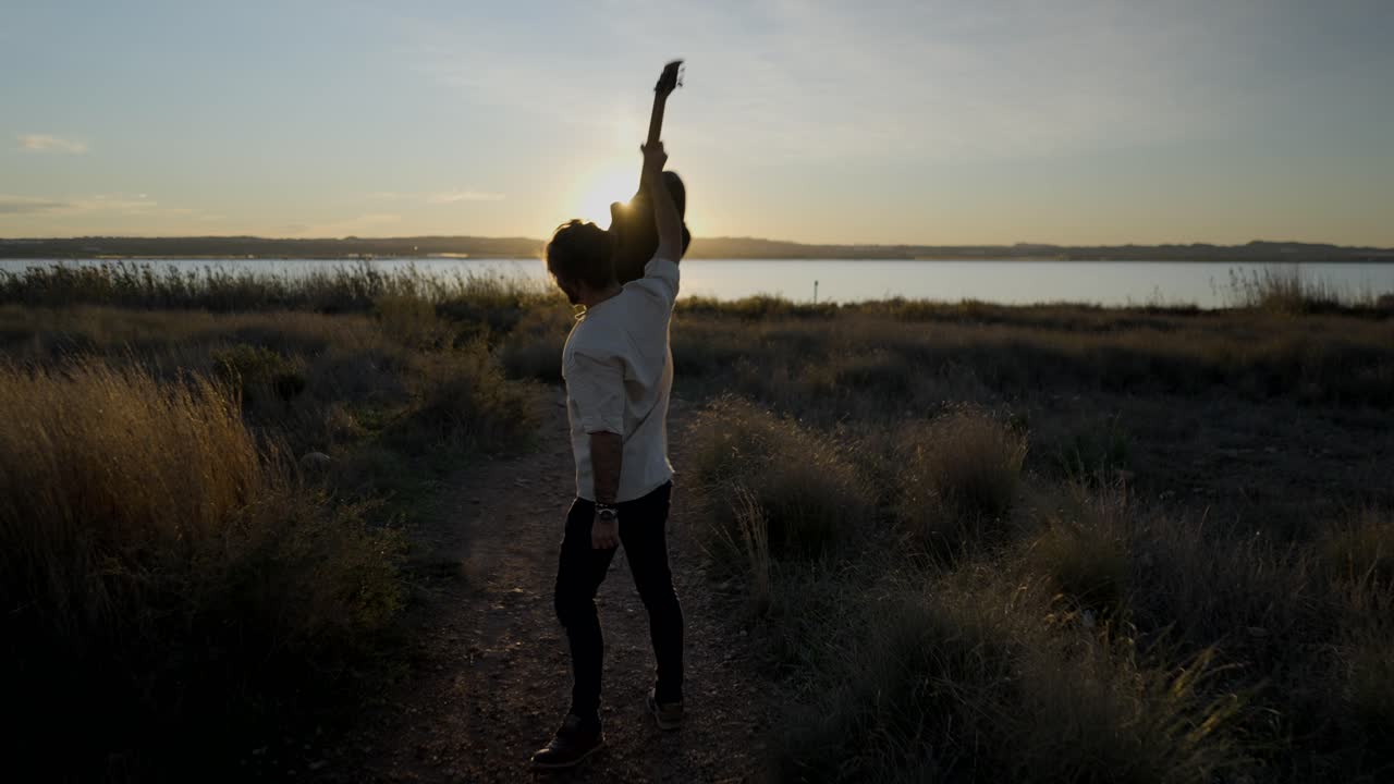 Man with Guitar at Sunset