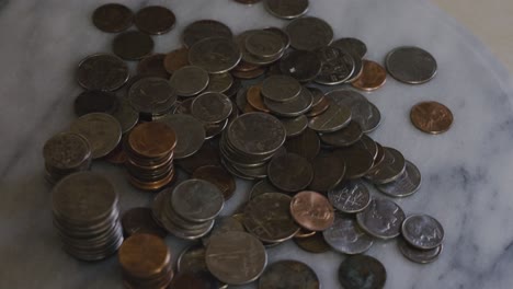 Coins-in-a-pile-spinning-in-frame-on-a-table