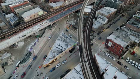 people, cars and a train on the streets of wrigleyville, chicago - aerial view